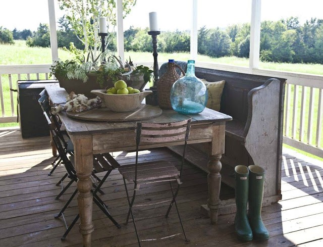 Fall farmhouse porch with antique farmhouse table and church pew featured at Talk of the Town - www.knickoftime.net