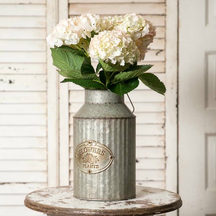 Use a Farmhouse Style Metal Flowers Plant Can instead of a traditional vase.